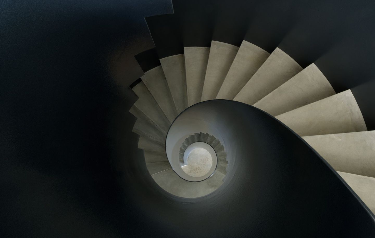 Steel and concrete spiral staircase at Beachfront house at Tamarama Sydney designed by Durbach Block Jaggers Architects