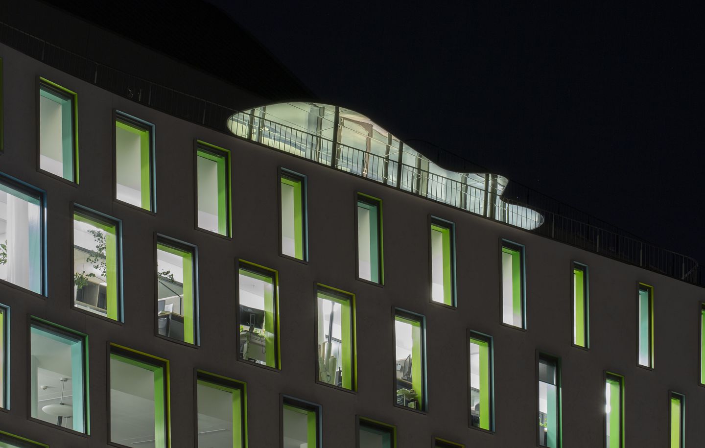 UTS Thomas Street  Close up view of coloured framed windows at night at university campus at UTS Ultimo Sydney designed by Durbach Block Jaggers Architects