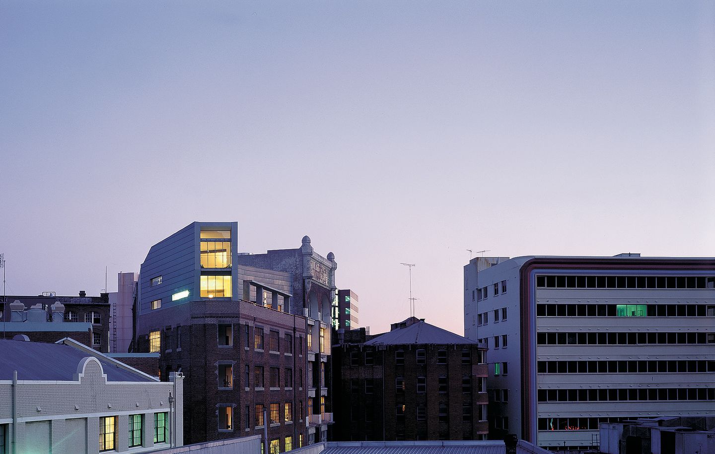 Cityline shot of penthouse apartment on top of an old industrial building in Surry Hills Sydney designed by Durbach Block Jaggers Architects