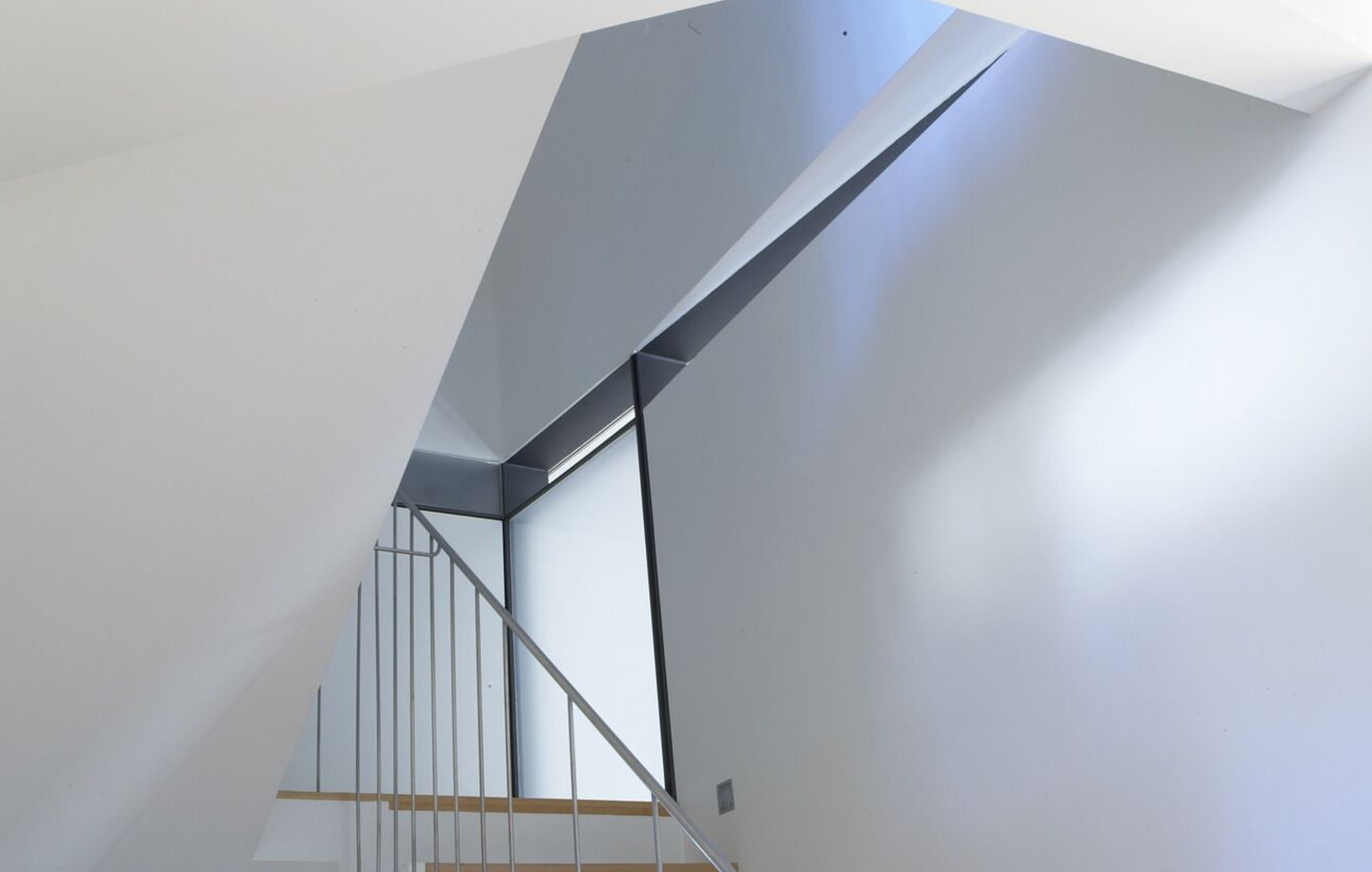 Curved white plastered stairwell with fine steel handrail and windows from house in Bellevue Hill Sydney designed by Durbach Block Jaggers Architects